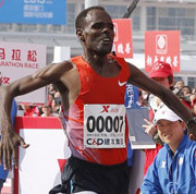 Getachew Terfa Negari of Ethiopia crosses the finishing line to claim the men's title at the 2013 Xiamen International Marathon in South China's Fujian province on Jan 5, 2013, by setting a new course record of 2:07:32. [Photo by Cui Meng / Asianewsphoto]