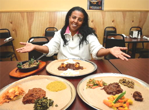 At Mariam's Ethiopian restaurant co-owner Beleteshachew Mulata sits with several of her culinary creations. (DONNA FISHER / 
