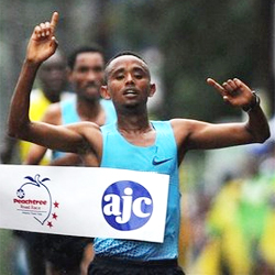 Mosinet Geremew, of Ethiopia, holds up his arms after winning the AJC Peachtree Road Race, Thursday, July 4, 2013 at Piedmont Park, in Atlanta. Up to 60,000 runners ran or walked in the rain to complete the 10K race. (AP Photo/Atlanta Journal-Constitution, Johnny Crawford) Read more: RN-T.com - Thousands run Peachtree Road Race in the rain 