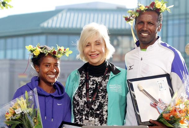 Tigist Tufa, left, and Fikadu Lemma, right, both of Ethiopia, stand with Susan Sundlun, wife of former RI Governor Bruce Sundlun, after taking top honors at the Rock 'n' Roll Providence Half Marathon Sunday morning. Lemma won the men's race in 1 hour, 9 minutes and Tufa finished first among the women and second overall in 1:10:51.(The Providence Journal / Bob Breidenbach)