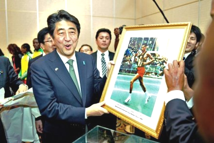Japan's prime minister Shinzo Abe kicks off a visit to Ethiopia by meeting the country's running stars and receiving a gift from the son of late barefoot marathon legend Abebe Bikila. (Credit: AFP) 