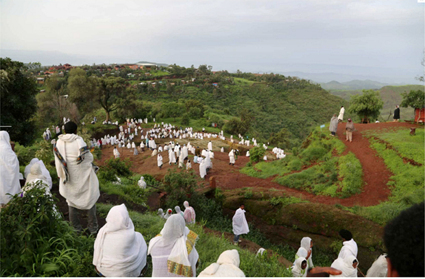 The faithful wend their way towards the Bet Giyorgis â€“ the 50ft-tall Church of St George carved into the volcanic rock of Lalibela by hand, shaped like a giant Greek cross (Photo: Evgeny Lebedev)