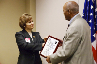 Rep. Suzanne Bonamici presented Taye Yemeru with the FAA's Charles Taylor Master Mechanic Award, which honors selected senior mechanics who have worked in aviation maintenance for at least 50 years, in a surprise ceremony earlier this month.(Hannah Leone/The Oregonian) -  